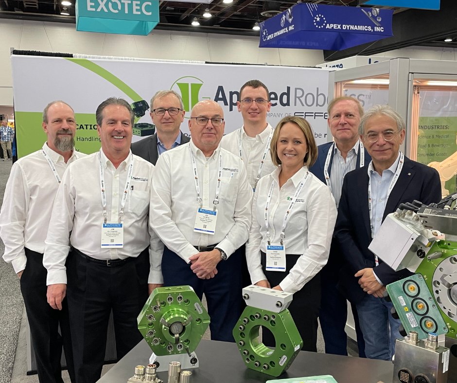 Applied Robotics Team at a tradeshow in front of tool changers.